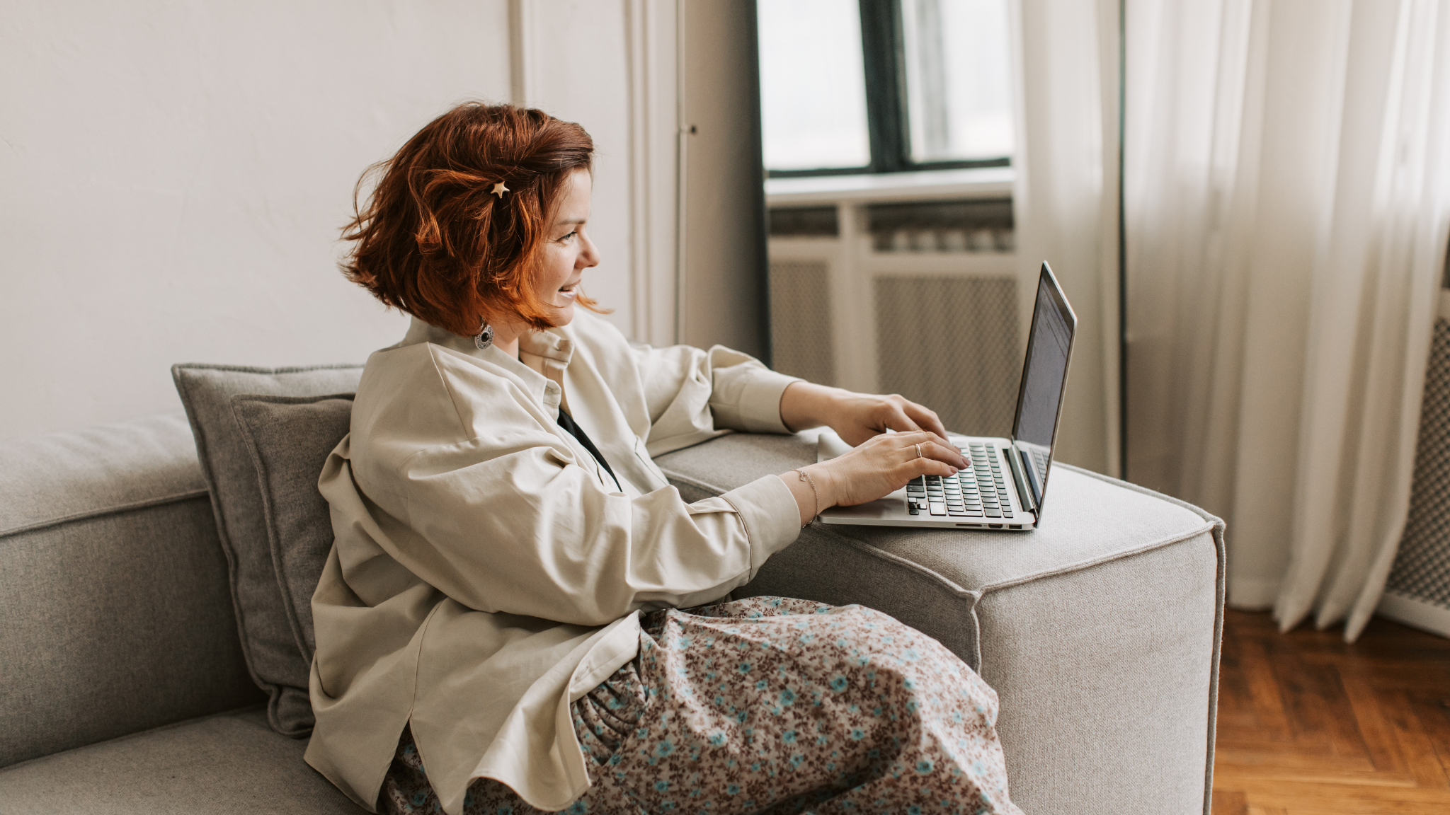 A woman checking her IRS tax account online on a laptop from home to review her tax balance and IRS debt.