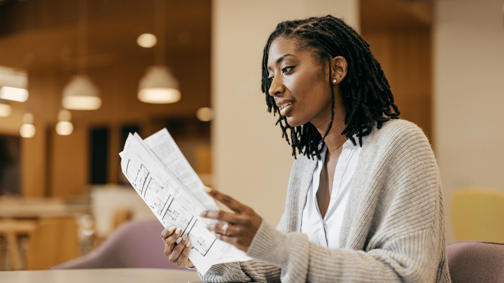 Homeowner reviewing property documents at a table, illustrating how IRS tax liens can impact property ownership and financial decisions in 2026.