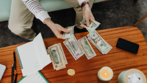 A stressed taxpayer reviewing an IRS balance due notice at a desk, representing the IRS collection process for tax debt over $10,000.